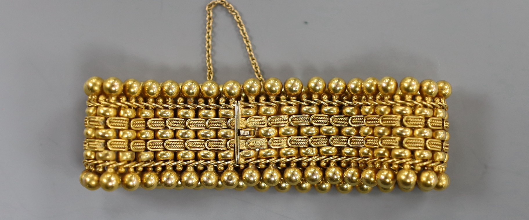 A yellow metal Etruscan style bracelet, 16cm, 38 grams.